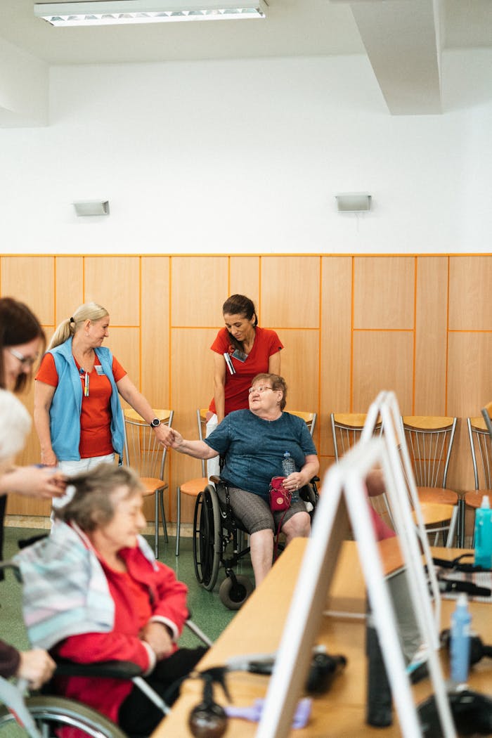 Healthcare professionals interact with elderly individuals in a care facility.